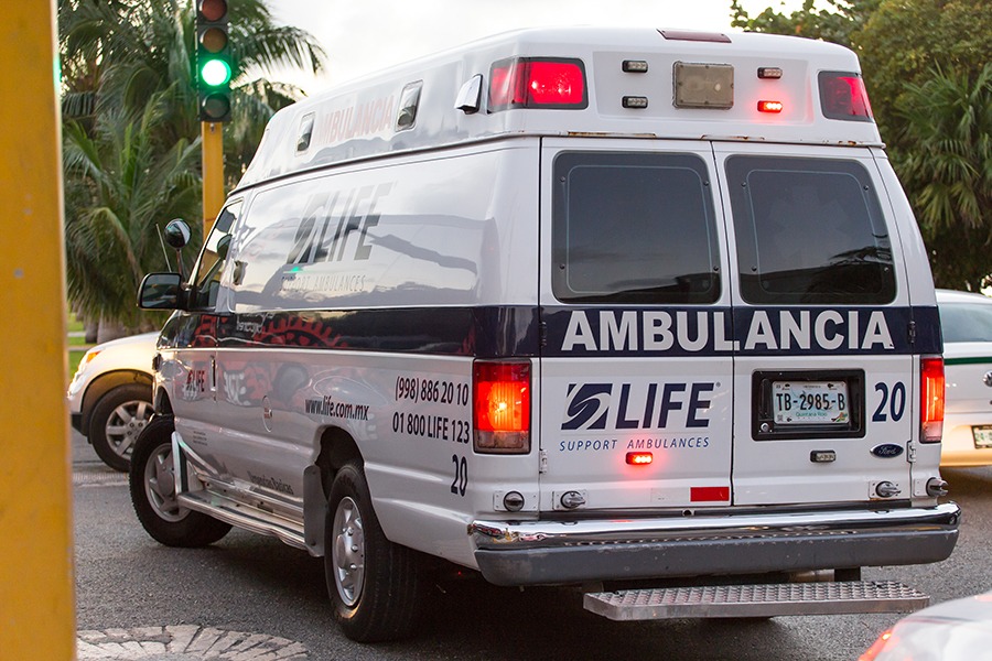 Ambulance car at the street road with blinking lights. Helping p